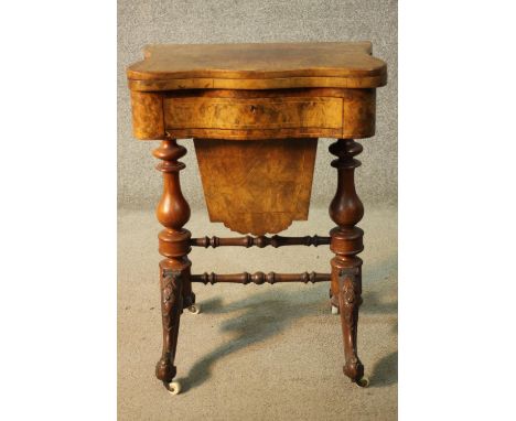 A Victorian burr walnut fold over top games and work table with inlaid chess and backgammon boards above fitted drawer and sl