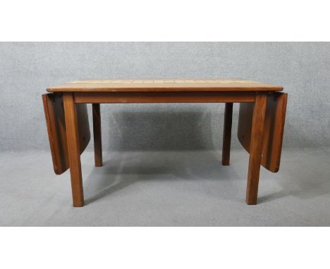 A 1960's vintage teak drop flap dining table with stoneware tile inlaid surface raised on square section supports. H.72 W.230