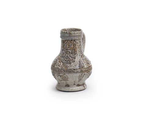 A small Cologne/Frechen stoneware jug (Bartmannskrug), late 16th centurySalt-glazed stoneware, decorated with a bearded face-