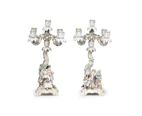 A pair of Meissen figural candelabra allegorical of Autumn and Winter, late 19th centuryEach with two figures on a domed base