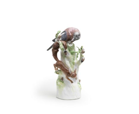 A Meissen model of a jay with squirrel, circa 1740Modelled by J.J. Kaendler, perched on the top of a high tree stump above a 