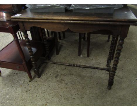 MID-20TH CENTURY OAK FRAMED FOLD-OVER CARD TABLE WITH GREEN BAIZE INTERIOR ON BOBBIN TURNED SUPPORTS 