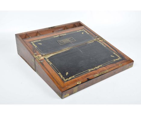 A mahogany and brass bound writing slope, late 19th Century
With presentation inscription dated 1897, with secret compartment