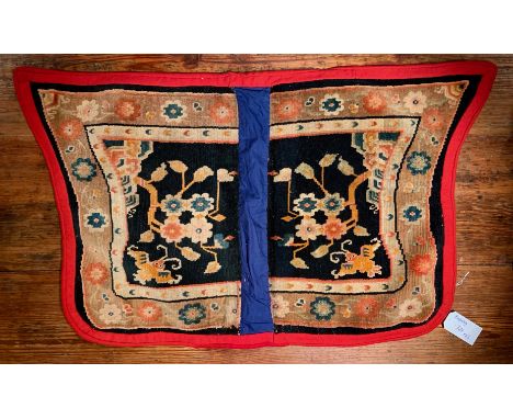 with dragon roundels within an inner pearl border on an ornate ground, 102.5 x 63cm: another "butterfly" type with floral kno