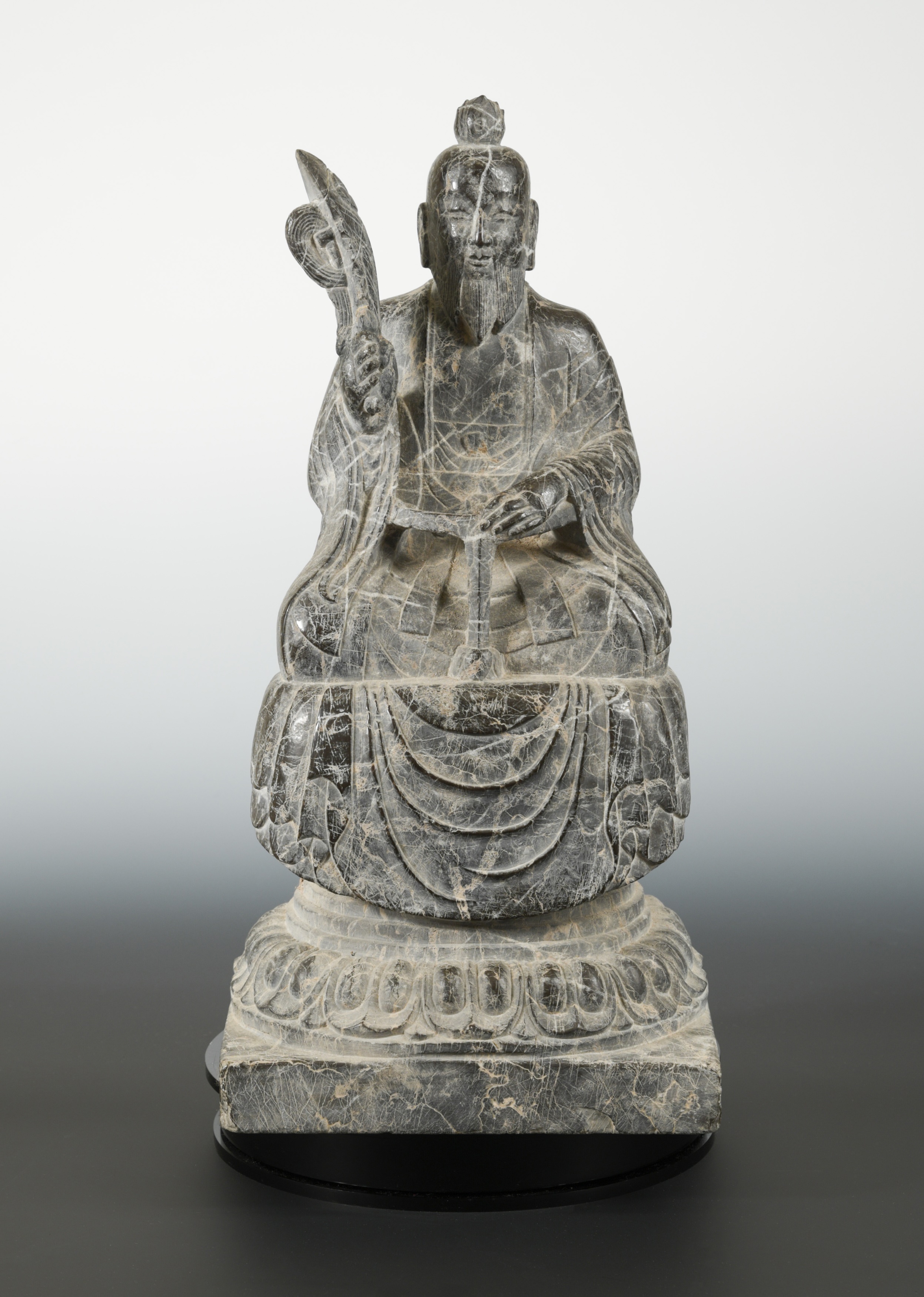 A Chinese veined marble seated figure of Laozi, in Northern Wei style
