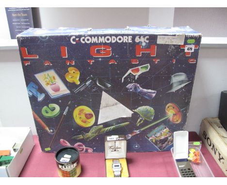 Boxed Commodore 64C Computer Pack, with data cassette player and twenty nine software and game titles, with light gun.