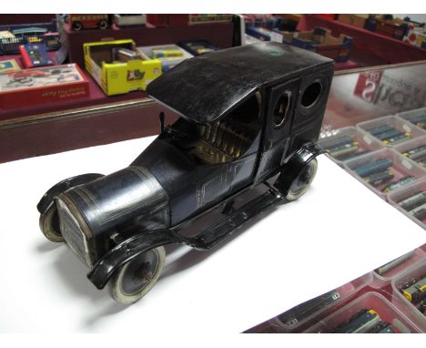 A Circa 1920 Tinplate Brimtoy Saloon, open front seat with slot for driver, two door access to enclosed back seat, finished i