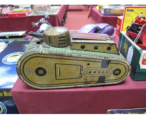 A Marx, USA Clockwork Tinplate Tank, gun turret to front, operating hatch at rear reveals figure with gun dressed in red, app