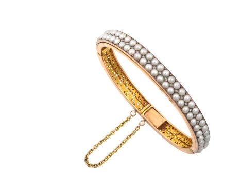An Early 20th Century Split Pearl and Diamond Bangletwo rows of split pearls spaced by rose cut diamond accents, in white and
