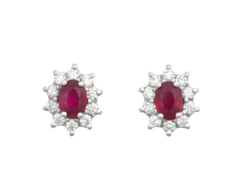 A Pair of 18 Carat White Gold Ruby and Diamond Cluster Earringsthe oval cut rubies within borders of round brilliant cut diam