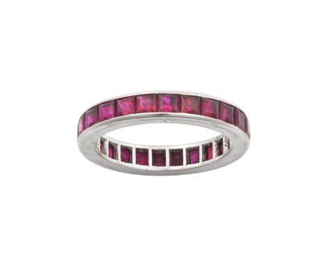 A Ruby Eternity Ringthe calibré cut rubies in a white channel settingfinger size OThe ring is in good condition, however one 