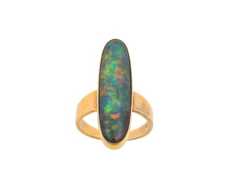 A Black Opal Ring the oval cabochon black opal in a yellow millegrain setting, to a plain polished shankfinger size K1/2The r