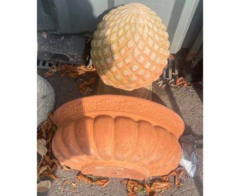Terracotta wall planter and a terracotta acorn figure 