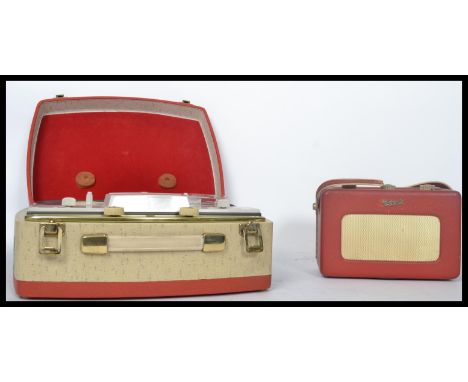 A vintage portable reel to reel tape player together with a vintage Roberts radio.