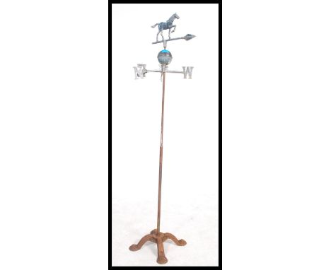 An early 20th century cast metal weather vane having a horse to top raised on a cast metal quadruped base.&nbsp;Measures 143c