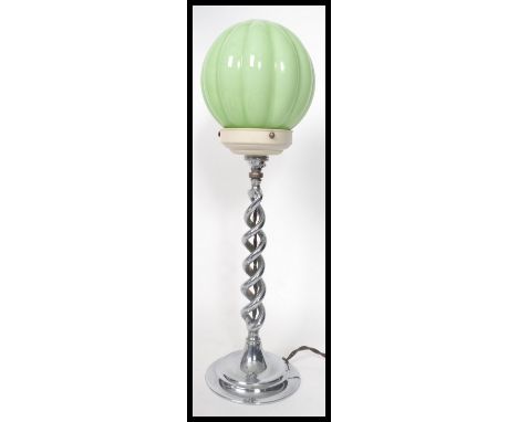 A vintage 20th century Art Deco chrome table lamp having a segmented green glass shade. The lamp raised on a circular base wi