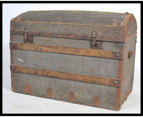 A Victorian wooden bound dome top steamer trunk chest having a dome top with clasps to front having open storage set within. 