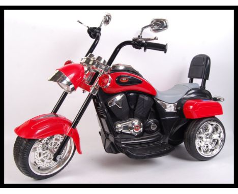 A large scale rechargeable ride on children motorbike. In fully working order with various buttons such as engine button &amp