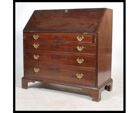 A 19th century Georgian mahogany bureau having a drop front opening to reveal a writing desk area fitted with many drawers an