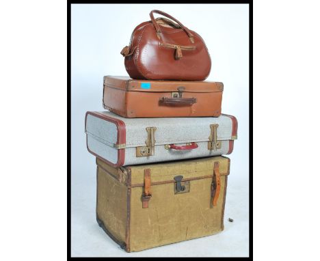 A collection of travel trunks / suitcases dating from the early 20th century to include a steamer trunk with Bristol Retailer