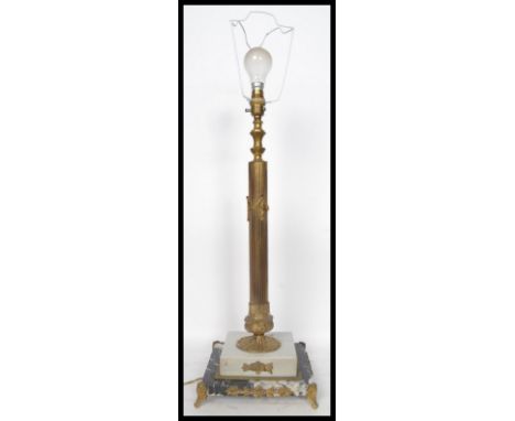 A 20th century brass table lamp having a gilt ormolu column raised on a stepped square marble base. Measures 76 cm high.