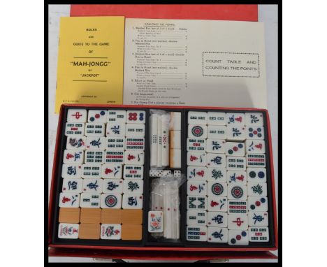 A vintage 1960's Oriental Mahjong set having wooden and resin playing pieces held within a vinyl box / carry case. Measures 2