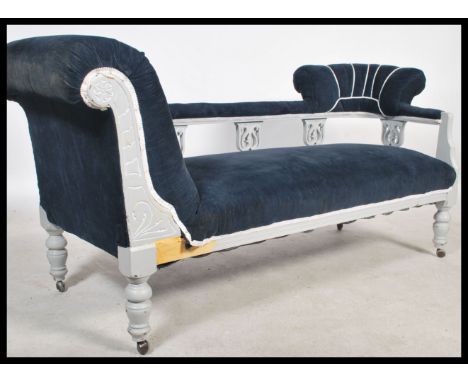 A late Victorian shabby chic chaise longue sofa settee being painted white with blue cord upholstery. The white frame with pi