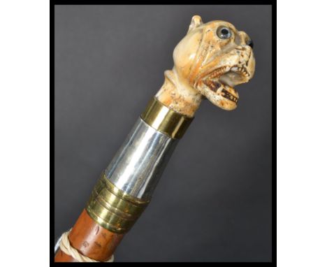 A 19th century Victorian silver walking stick cane having a tapering malacca shaft with silver hallmarked collar and grotesqu