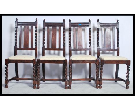 A set of 4 1920's oak barleytwist dining chairs. Raised on barley twist legs united by stretchers having drop in seats with r