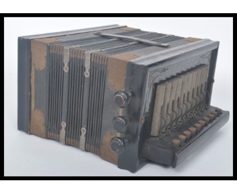 A vintage 20th century German Universe accordion musical instrument having buttons and keys. Measures 14.5 cm high, 28 cm wid