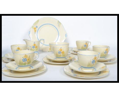 A 20th century Art Deco hand painted China tea service by Newhall in the Nirvana pattern, consisting of cups, saucers, side p