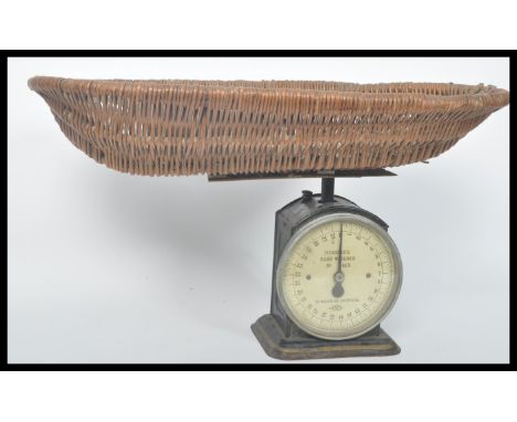 A vintage early 20th century Hughes's baby weight weighing scales by Salter. Raised on a square base the ebonised metal body 