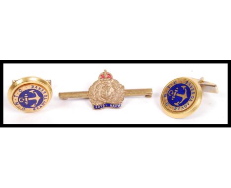 A Royal Navy bar brooch in enamel with yellow metal together with a pair of Naval cufflinks in yellow metal with ntoation GNT