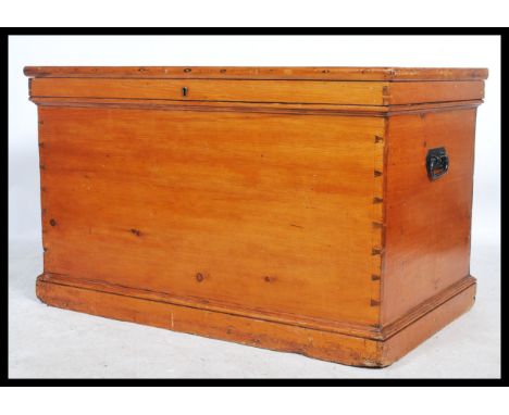 A good 19th century pine cabinet makers trunk - chest. Pine panelled body with hinged top opening to reveal a flame mahogany 