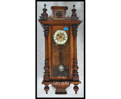 A 19th century Victorian walnut vienna regulator wall clock in the manner of Gustav Becker having an enamel dial with swing p