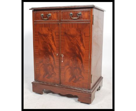 A 20th century Georgian style&nbsp;flame mahogany hi-fi / entertainment cabinet having a hinged top and shelved interior rais