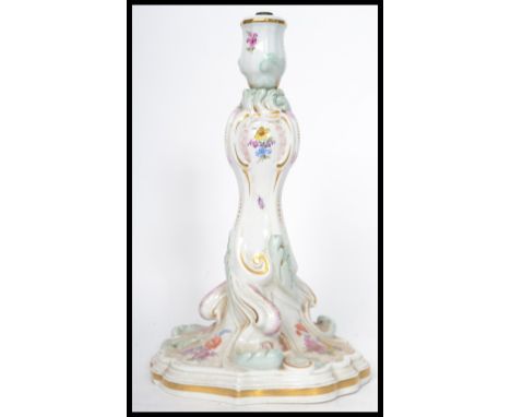 A 19th century Meissen ceramic table lamp of scrolled form hand painted with floral sprays and gilt detailing. Measures 26 cm