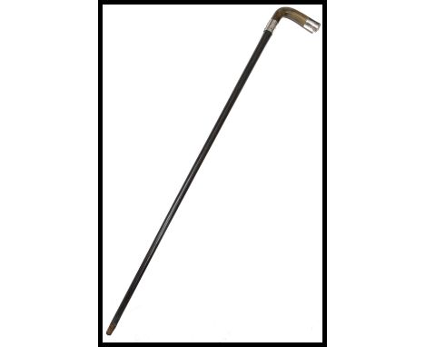 A 19th century silver hallmarked walking stick cane having a tapering ebonised shaft with shaped horn handle. The silver coll