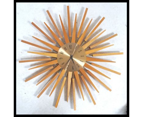 A vintage retro 20th century Paico teak sunburst / atomic wall clock