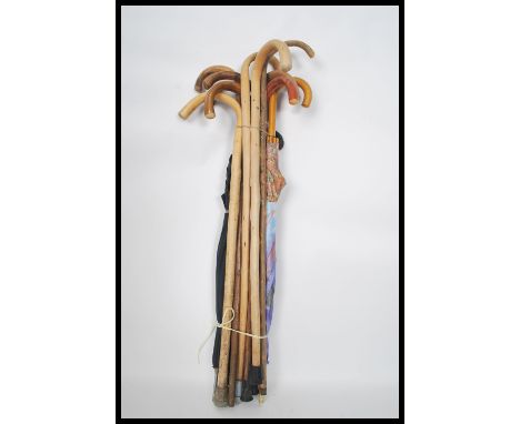 A collection of vintage 20th century walking sticks together with vintage gentleman's umbrella's