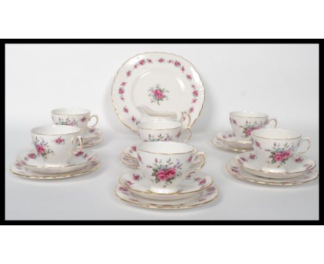 A vintage mid 20th century bone China tea service by Queen Anne, consisting of cups, saucers, creamer and sugar bowl.