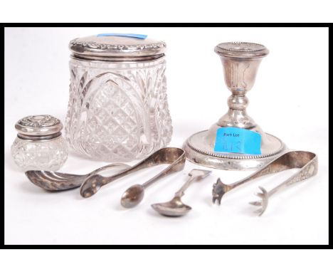 A hallmarked silver stub candle stick of larger form having a gadrooned circular base along with silver hallmarked topped cut