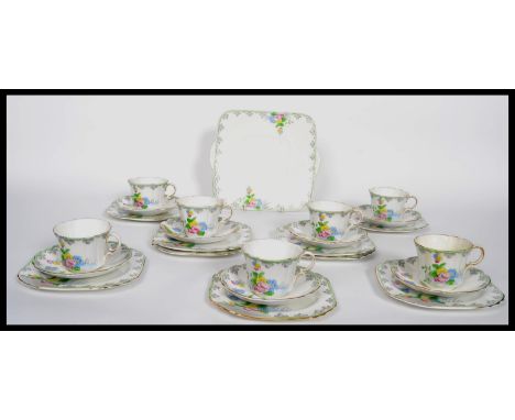 A 20th century Art Deco Bone China part tea service by Heathcote China having hand painted flower detail, consisting of cups,