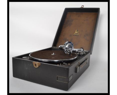 A vintage early 20th century portable gramaphone by Odeon. Set in the black carry case with deck and handle. Case measures 15