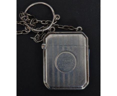 An early 20th century George V vesta case of octagonal form having an engine turned decoration with engraved circular monogra