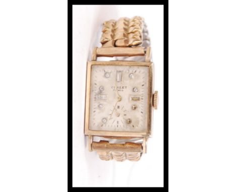 A gentleman`s 14k gold Chalet rectangular 17 jewel wrist watch, on rolled gold expanding bracelet. The silvered dial having g