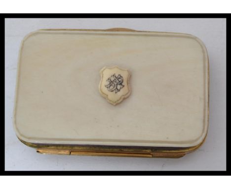 A vintage 19th century ivory and gilt metal purse with monogrammed armorial crest to front push lever to side and and a three