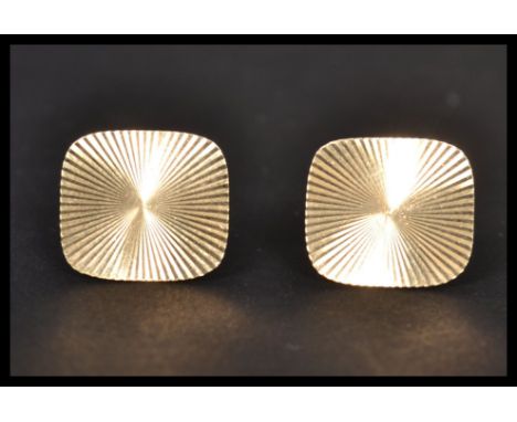 A pair of 9ct / 375 marked gold gentlemans cuff links ( cufflinks ) having engine turned sunburst lozenge panels to each. Hal