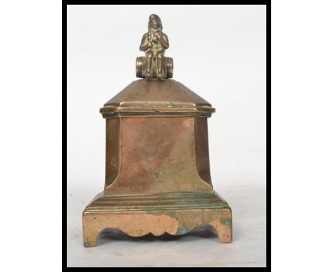 An rare 18th century Georgian brass tobacco table box having sloped sides with the lid having a naval figure finial sat on a 