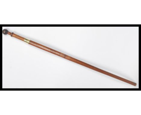 A vintage early 20th century walking stick cane having a hidden twist of section revealing a secret compartment to the handle